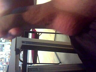 Guy discreetly strokes his cock in a crowded internet cafe