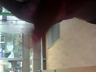 Guy discreetly strokes his cock in a crowded internet cafe