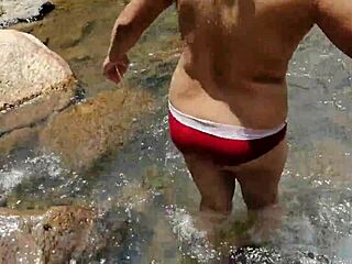 Crossdressing Person Washing in a River Scene