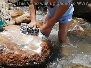 Crossdressing Person Washing in a River Scene
