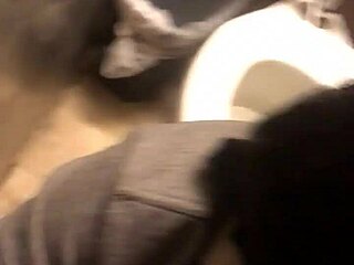 Gay couple gives a blowjob in a shop