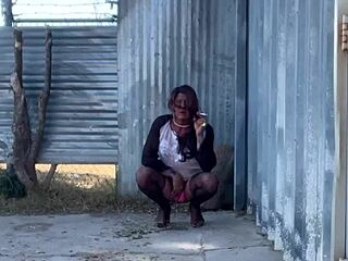 Staci takes a piss in fishnets and heels outdoors