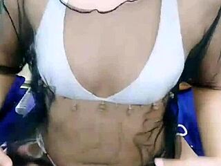 An Asian stripper begins her teasing performance, slowly ripping off her clothes to reveal her seductive body in a captivating striptease.