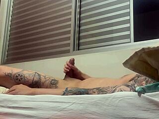Watch this tattooed amateur soloboy masturbate his cock solo in the room