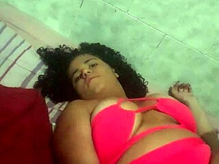 This pregnant babe is casually masturbating solo in her room