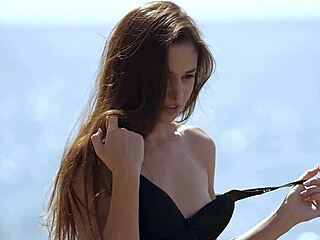 Demi fray teasingly undresses on the beach.
