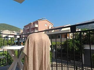 Topless beauty enjoys outdoor solo pleasure on a balcony