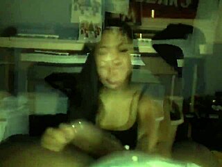 Young and petite Asian woman deep throats a big black cock
