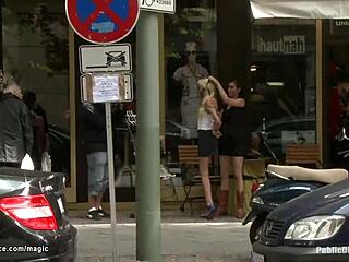 A blonde is gagged and tied up in a public place