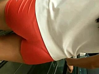 Beautiful girl showing off her curves in tight shorts at the market