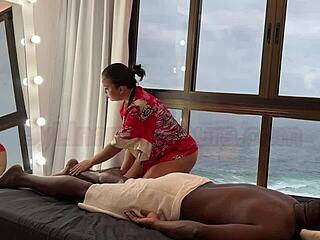 Asian masseuse gives a relaxing massage to a black man