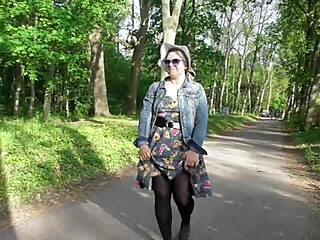 Is that hairy mature nude under see-through dress in park?