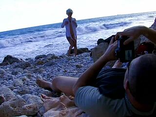 A blonde with tattoos having a big breast and a big dick lover having sex on the beach