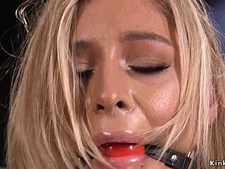 The busty blonde inked beauty endures device bondage