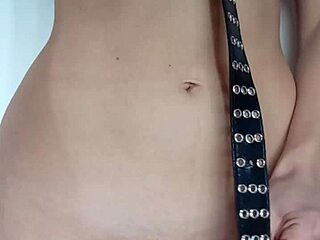 Punishment with a belt and spanking of the tits and pussy