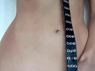 Punishment with a belt and spanking of the tits and pussy