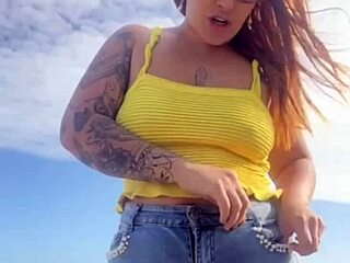 Young exhibitionist flashes in a revealing bikini on the beach