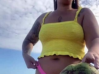 Young exhibitionist flashes in a revealing bikini on the beach