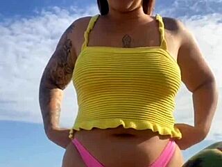 Young exhibitionist flashes in a revealing bikini on the beach