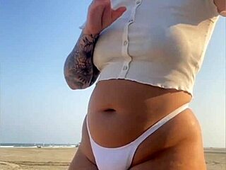 redhead flashing her swollen pussy lips on the beach today