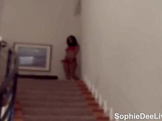 Sophie Dee masturbates wet pussy on stairs