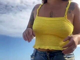 Young exhibitionist flashes in a revealing bikini on the beach