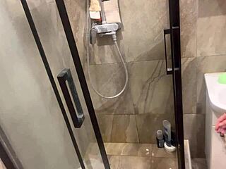 Hey, peep this girl with big boobs getting oiled up and shaved in the hidden shower.