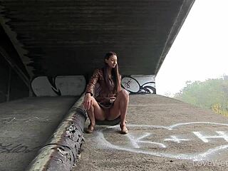 Kitty performs an outdoor solo pissing scene in a public setting