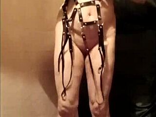 French milf maid bound in leather harness for outdoor display