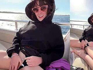 A girl is having fun with a guy on his yacht at sea
