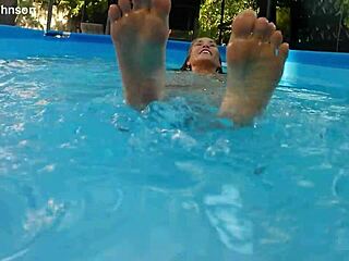 melissa the mermaid swims in the pool with her brown eyes and tattoo