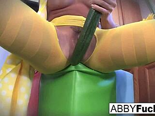 Surreal Kitchen Dress-Up: Abigail's Emotional Journey with Her Giant Cucumber, Revealing Big Tits and Pussy in the Kitchen.