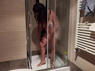 A hot MILF with big boobs shaves her pussy in the shower