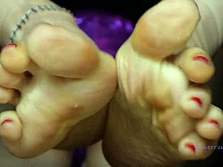 This petite mistress with red toenail polish dominates sensually, making me sweat over her small feet 😍