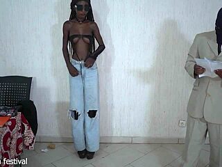 African secretary removes her clothes in front of boss due to forgotten costume, revealing skinny body.