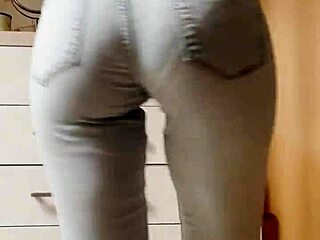 The petite blonde in tight jeans is dancing on the kitchen for you