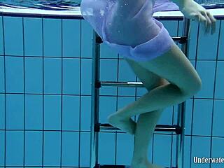 Aneta in a striking purple dress at the pool