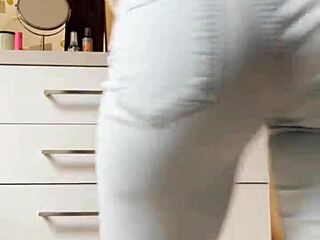 The petite blonde in tight jeans is dancing on the kitchen for you