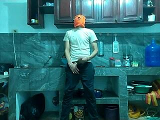 25-year-old man masturbates big cock from flaccid to erect in kitchen.