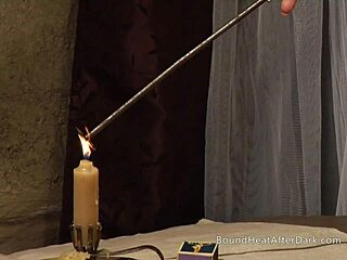A dominant woman in leather is punishing two tied lesbian slaves