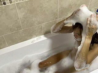 Brunette with blue eyes sings naked in the bath.