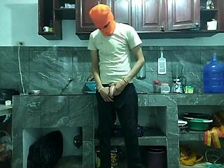 25-year-old man masturbates big cock from flaccid to erect in kitchen.