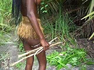 hot african native woman cooking in the jungle with small waist