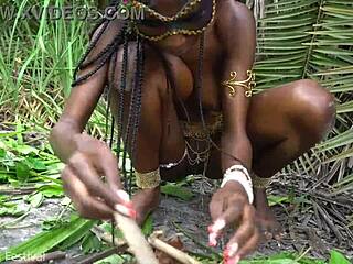hot african native woman cooking in the jungle with small waist