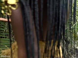 An African native woman cooks in the jungle kitchen surrounded by nature.