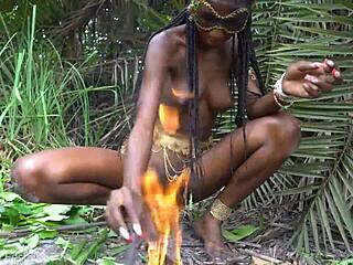 hot african native woman cooking in the jungle with small waist