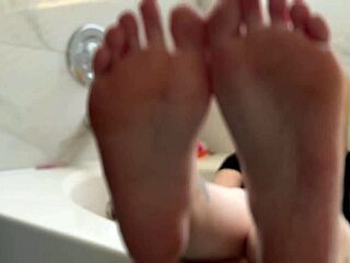 blonde babe casually shows off her oiled feet in a fetish video
