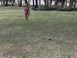 Monika Fox poses seductively in pink bikini on sunny beach.