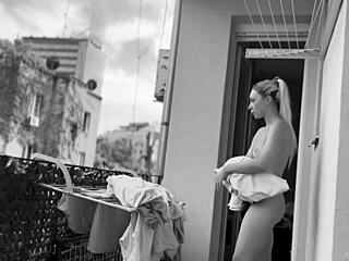 Naked chubby woman casually hangs laundry on balcony while neighbors watch her shaved pussy