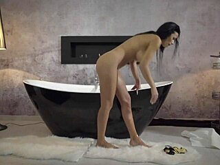 In a casual afternoon scene, mature milf Shalina Devine masturbates solo with her pierced nipples and big tits before bath time.